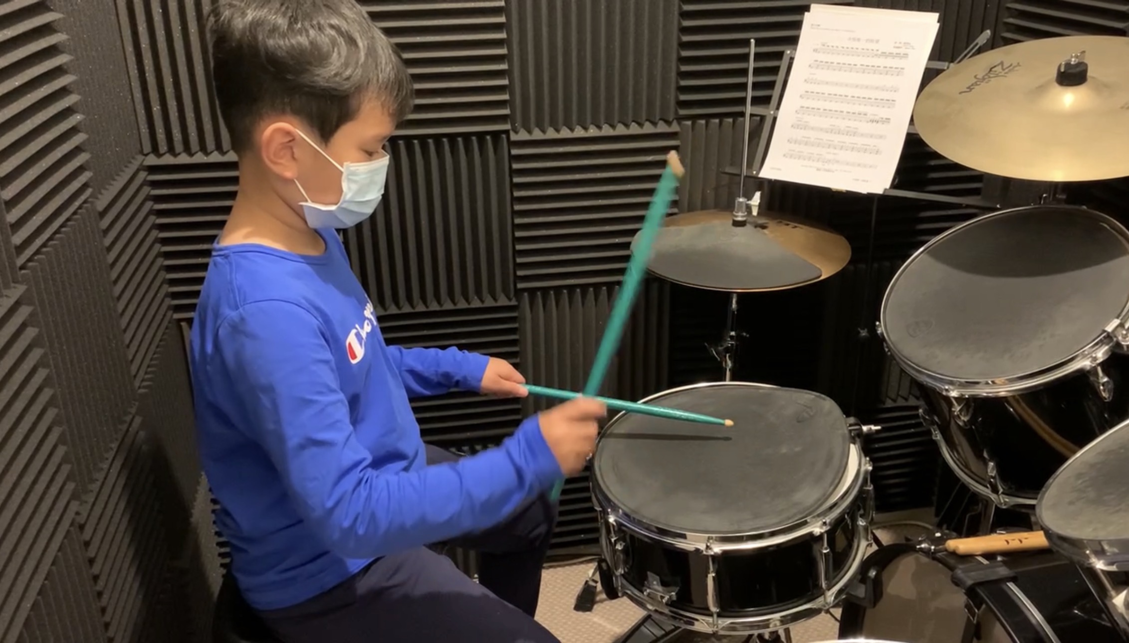 Student focused on an electronic drum kit lesson at iDrum Academy