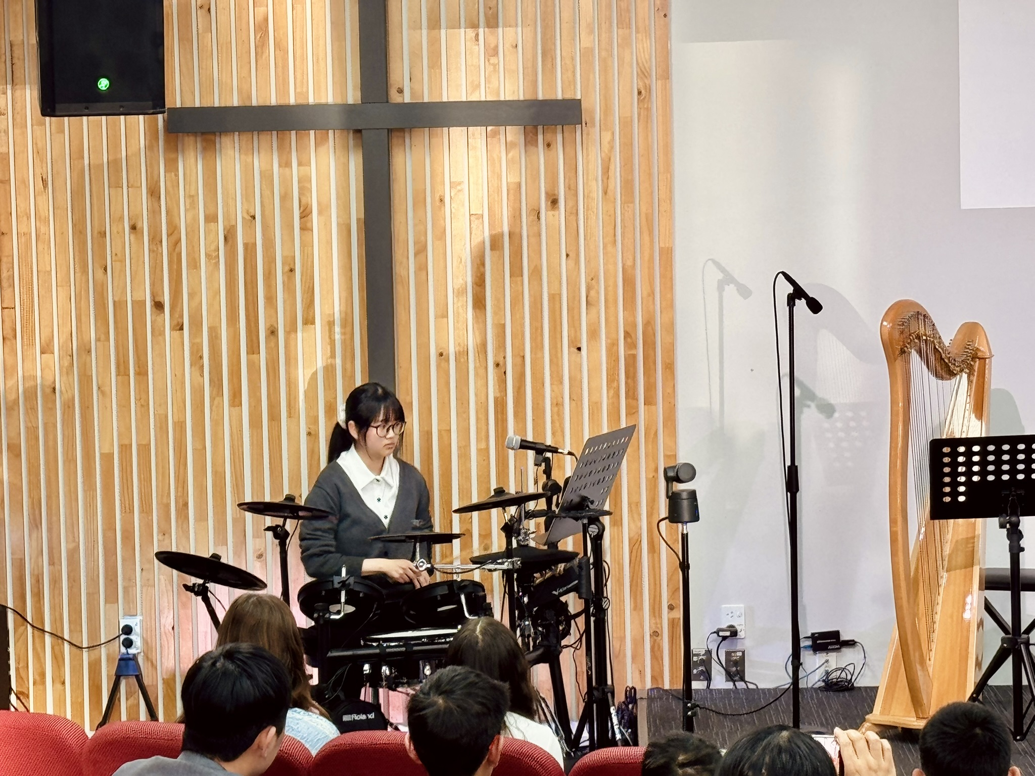 Student performing on a Roland electronic drum kit at an iDrum Academy recital
