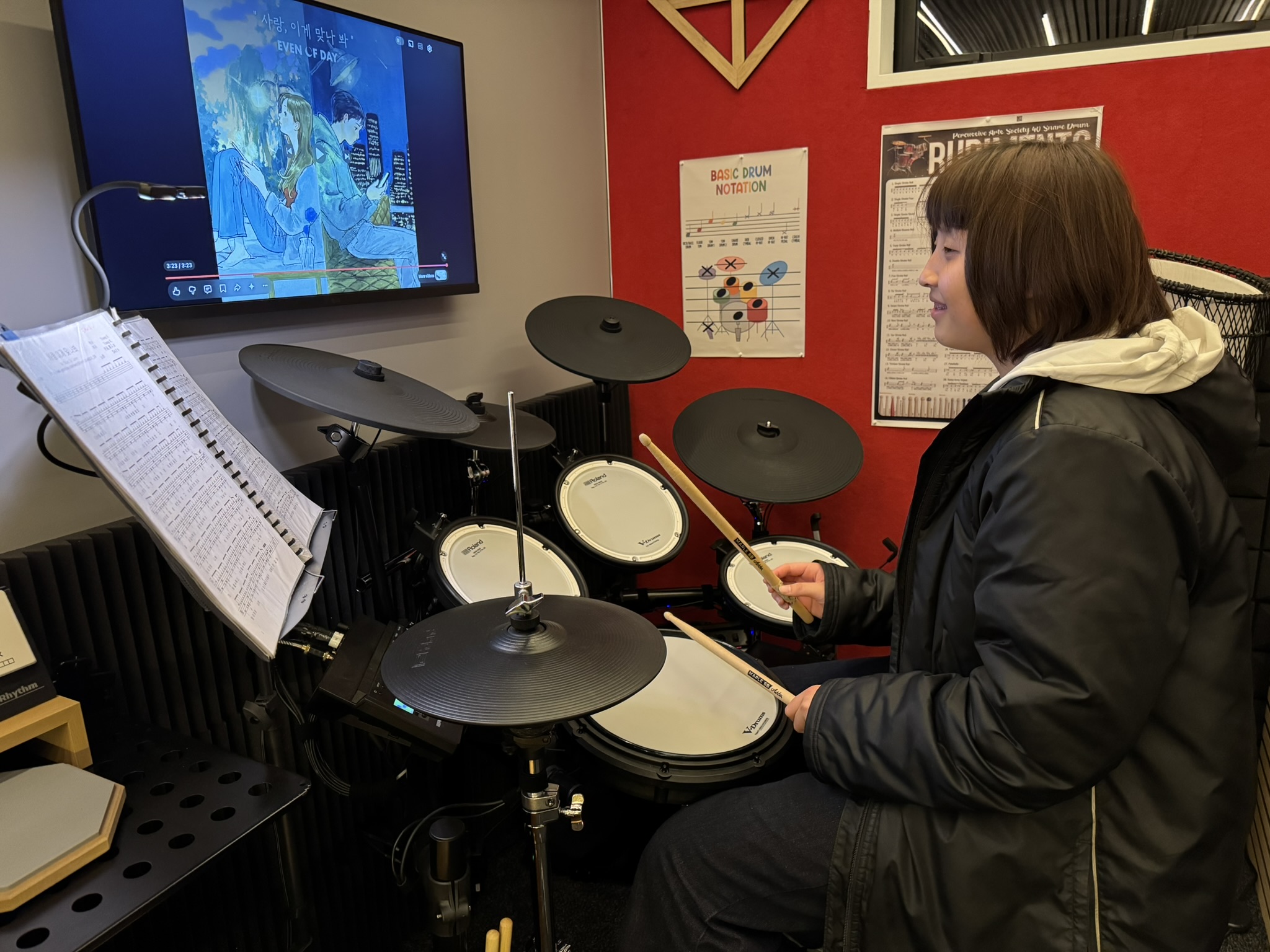 Student practicing rhythm patterns during a lesson